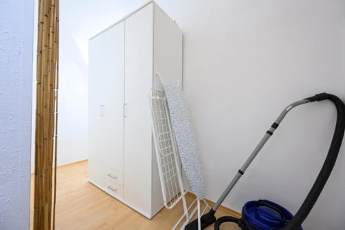 a room with a white cabinet and a vacuum at City Center Mödling in Mödling