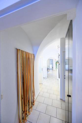 a hallway with orange curtains in a white room at City Center Mödling in Mödling