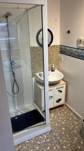 a bathroom with a shower and a sink at Caux-Breizh in Rohan