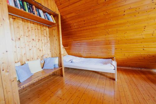a wooden room with a bed in a wooden wall at Ferienhaus Schöne Aussicht Ferienwohnung Gelb in Hemfurth-Edersee