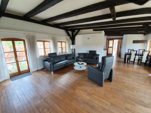 a living room with couches and a table and chairs at Über dem Kattsund in Eckernförde