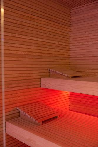 an empty sauna with red and orange at Regina City Hotel & SPA in Vlorë