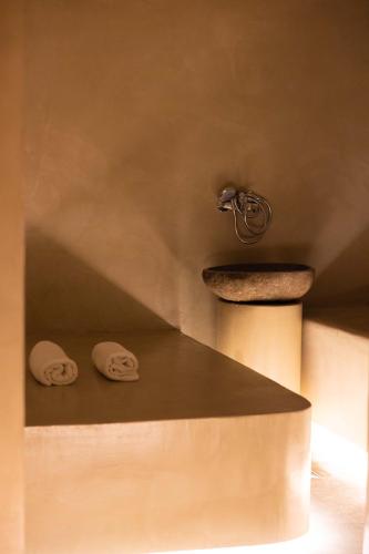 two face towels sitting on the floor of a bathroom at Regina City Hotel & SPA in Vlorë