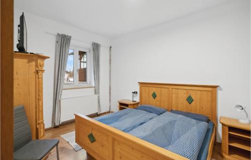 a bedroom with a bed with a blue comforter at 1 Bedroom Nice Apartment In Peiting in Peiting