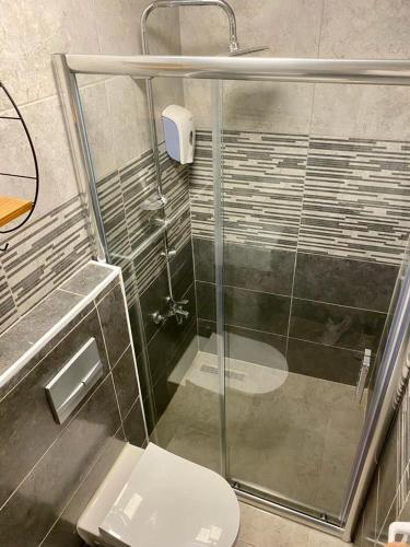 a bathroom with a glass shower and a toilet at Nest Hotel ANTALYA in Antalya