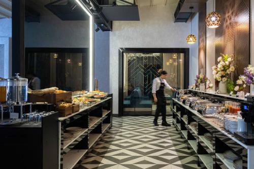 a man standing in front of a buffet line at FRANKFORT Expo Hotel in Tashkent