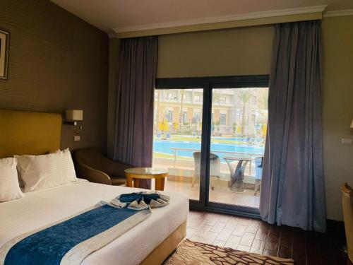 a hotel room with a bed and a view of a pool at Jewel Sport City and Aqua Park in Cairo
