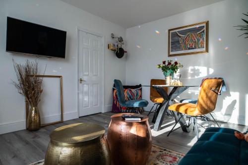 a living room with a table and chairs at Luxury ApArt Gallery Apartment 1 Near River & Free Parking in Bedford