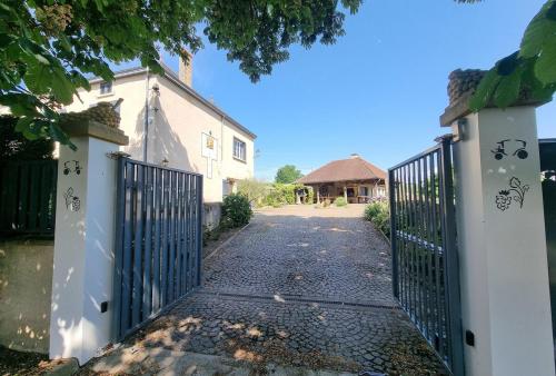a gate to a driveway with a house at La Maladire- Saint Martin Du Lac Burgundy 