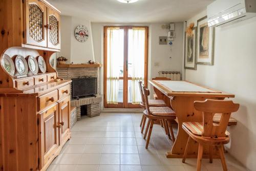 a kitchen with a table and chairs and a fireplace at SE034 - Senigallia, graziosa mansarda con vista mare in Senigallia