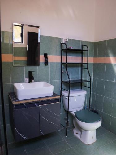 a bathroom with a toilet and a sink and a mirror at Casa Mate BeachFront HOUSES El Cuyo in El Cuyo