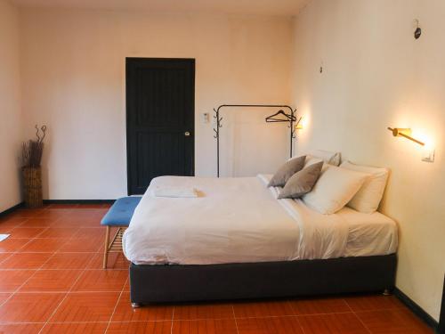 a bedroom with a bed with white sheets and pillows at Casa Mate BeachFront HOUSES El Cuyo in El Cuyo