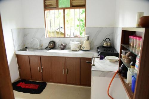 a kitchen with a sink and a window in it at Sanjee Villa Hikkaduwa in Hikkaduwa