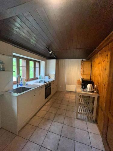 a large kitchen with a sink and a counter at Cosy mountain apartment 5min walk from Gondola in Fiesch