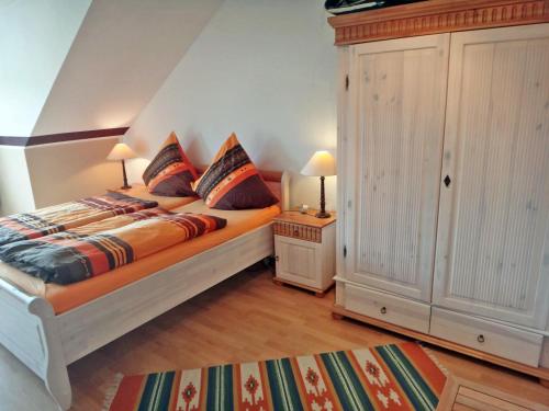 a bedroom with a large bed with two pillows at Fischreiher 2 in Kappeln