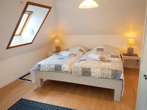a bedroom with a bed and a mirror on the wall at Fischreiher 1 in Kappeln