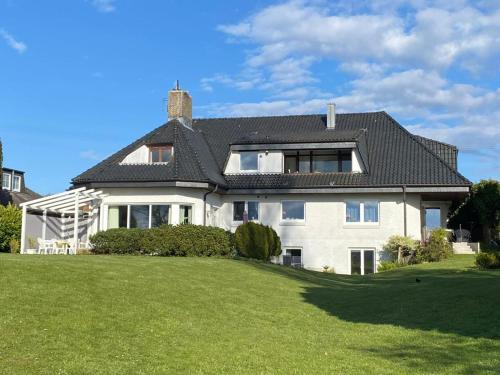 a large white house with a black roof at Möwe in Kappeln