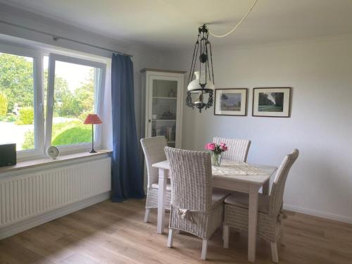 a dining room with a table and chairs and a window at Möwe in Kappeln