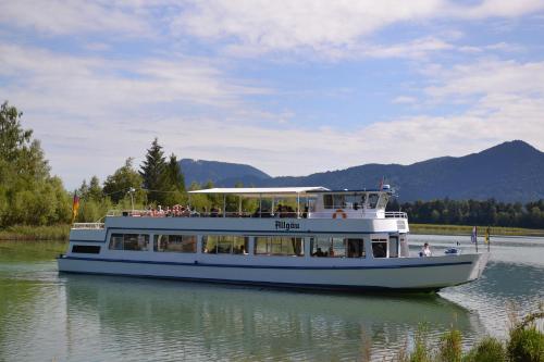 a boat on the water with people on it at Ferienbungalow Schlossblick in Füssen