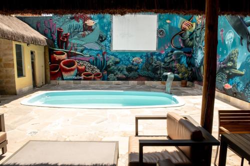a swimming pool in a room with a mural at Longboard Paradise Surf Club in Rio de Janeiro