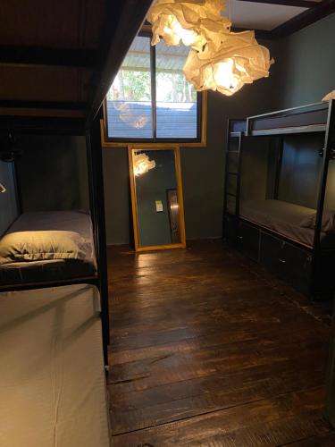 a room with two bunk beds and a mirror at Bibhitaki Hostels Palolem Beach in Palolem
