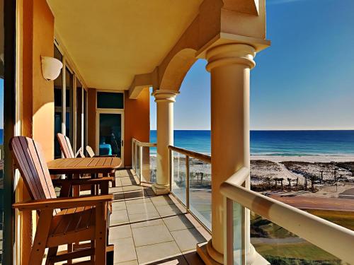 a balcony with chairs and a view of the ocean at Portofino Island Resort #1-702 in Pensacola Beach
