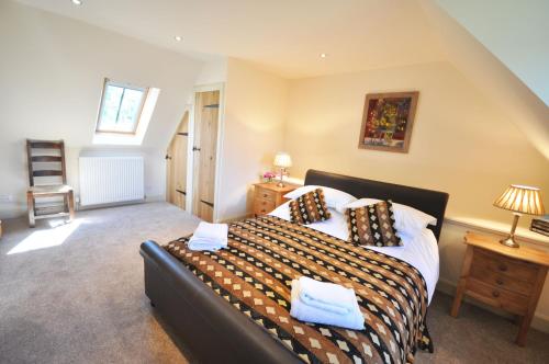 a bedroom with a large bed in a room at Old Mill Cottage in Kelso