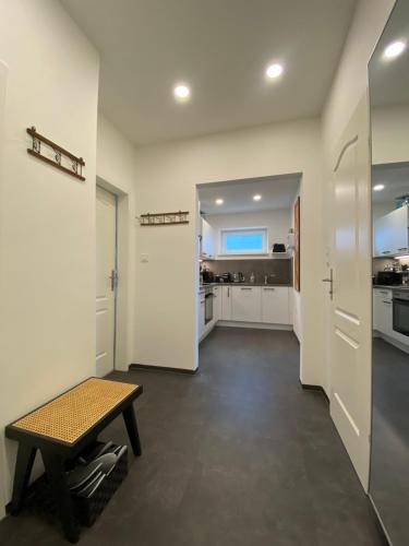 a large white kitchen with a table and a bench at ElegantLiving Graz, free parking in Graz
