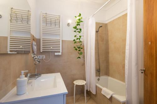 a bathroom with a sink and a bath tub at Sunset Cas Sastre in Alcudia