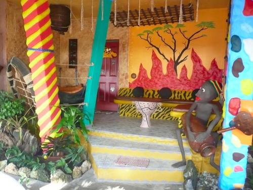 a toy house with a fire on the wall at Takatuka Beach Resort in Sipalay