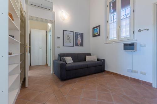 a living room with a couch and a window at Dimora Storica Manfredini nel cuore di Ferrara in Ferrara