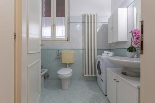 a bathroom with a toilet and a sink at Dimora Storica Manfredini nel cuore di Ferrara in Ferrara