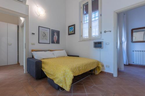 a bedroom with a bed with a yellow bedspread at Dimora Storica Manfredini nel cuore di Ferrara in Ferrara