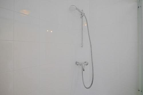 a shower with a shower head in a bathroom at Chalet Luttikduin Nr 07 - Callantsoog aan Zee in Callantsoog