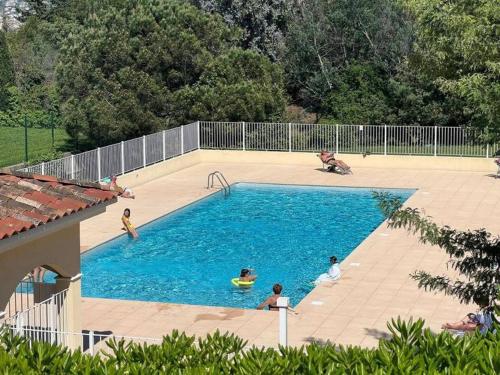 un groupe de personnes jouant dans une piscine dans l'établissement Cannes - 2 pièces résidence avec parc et piscine, à Cannes