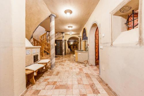 a hallway of a house with a tile floor and a kitchen at Naturoase Stegerhof Apt Margerite in Trodena