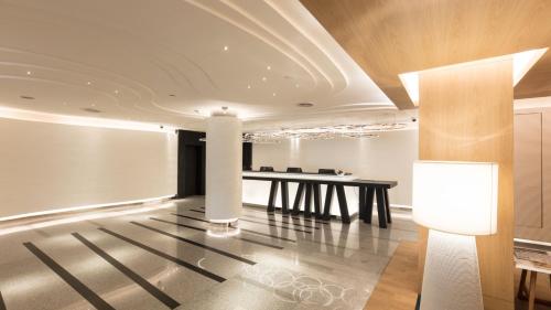 a dining room with a table and a lamp at Holiday Inn Bangkok by IHG in Bangkok