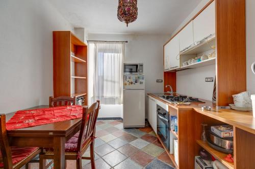 a kitchen with a table and a dining room at Entu Nou in Bortigali