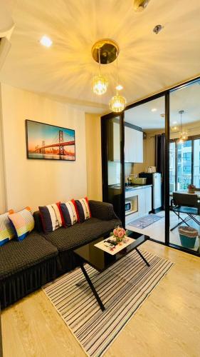 a living room with a couch and a table at The base Central Pattaya 631 by Numam in Pattaya Central