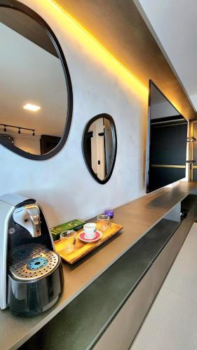 a bathroom with a sink and a mirror at Do lado do Lovina e do Fest Verão - c/ piscina in Cabedelo