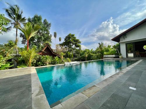 a swimming pool in front of a house at Graha Ayoe in Sidemen