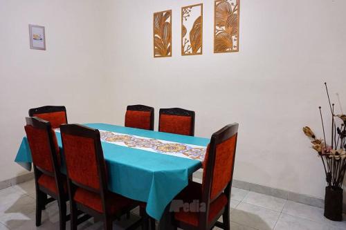 a blue table with chairs and a blue table cloth at Villa Tentram Puncak, 6 Kamar, Billiar, Karaoke in Paragajen