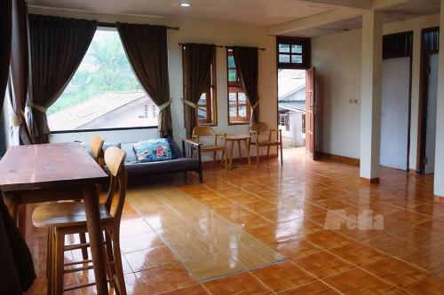 a living room with a couch and a table at Villa Tentram Puncak, 6 Kamar, Billiar, Karaoke in Paragajen