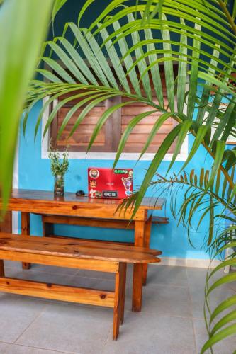 a wooden table with a red sewing machine on it at Back to the Beach Hostel - Pipa in Pipa