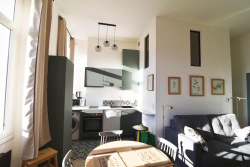 un salon avec un canapé et une cuisine dans l'établissement Charming studio very central and calm, à Cannes