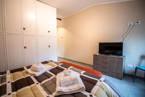 a bedroom with a bed and a flat screen tv at GG12 Parma Comfort & Parking Suites in Parma