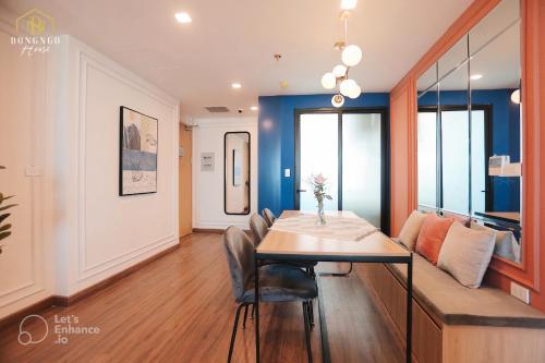a dining room with a table and a couch at FLC Sea Tower Condotel in Quy Nhon
