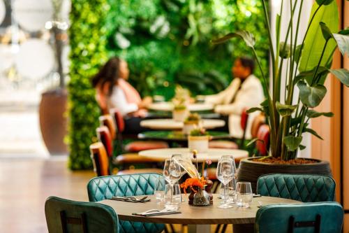 a group of tables and chairs in a restaurant at Novotel London Greenwich in London