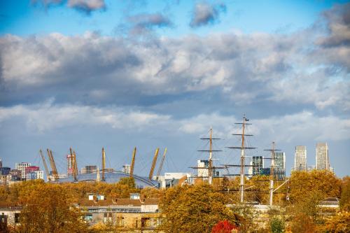 a view of a city with a tall ship and buildings at Novotel London Greenwich in London