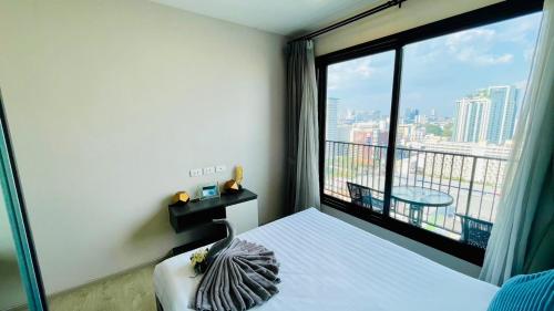a room with a bed and a large window at The base Central Pattaya 1005 by Numam in Pattaya Central